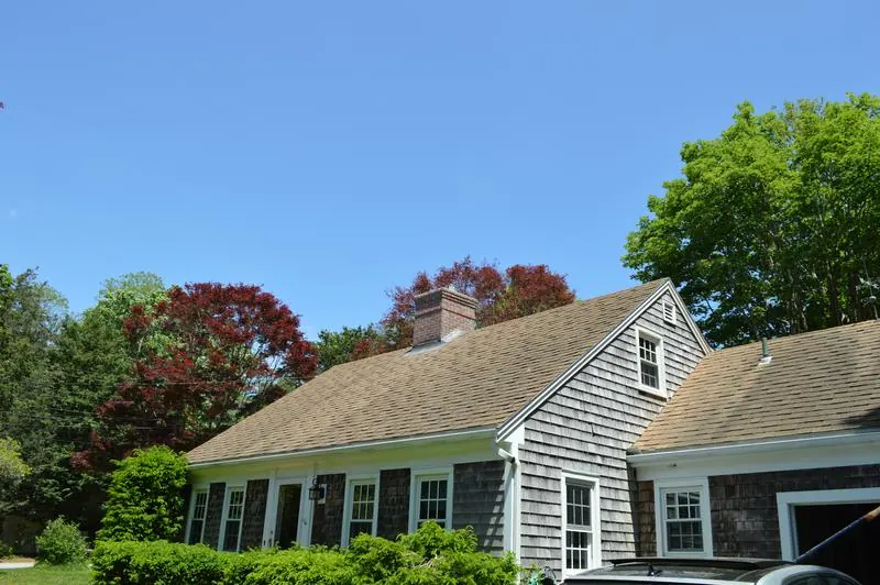 Brick chimney on a shingled Cape Cod house