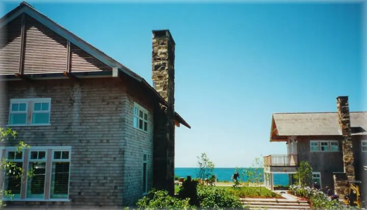 Stone chimneys on shingled homes near the shore