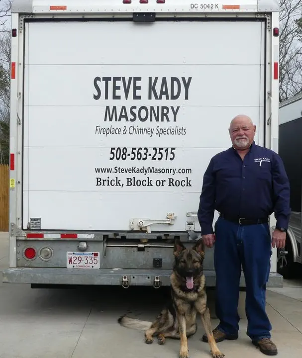 Steve Kady standing beside his Steve Kady Masonry truck and a German shepherd