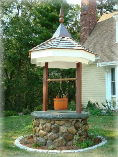Fieldstone wishing well with a shingled roof
