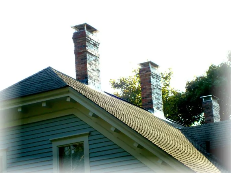 Brick chimney with copper flashing on a gabled roof